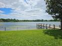 Peaceful lakefront view with a dock and grassy area at 3651 S Rosalind Ave, Orlando, FL 32806