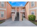 Exterior view of building entrance with stairs and landscaping at 8709 Rockingham Ter # A, Kissimmee, FL 34747