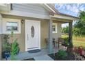Inviting front porch with seating area and landscaping at 20106 Sunset Landing Ave, Groveland, FL 34736