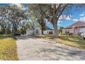 House with driveway and surrounding trees at 2080 Cobblefield Cir, Apopka, FL 32703