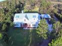 White farmhouse on large lot with mature trees at 2293 Eldorado Ct, St Cloud, FL 34771