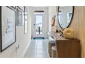 Light and airy entryway with wood console table and modern wall art at 2782 Puffin Pl, Davenport, FL 33837