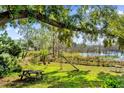 Large backyard with a lake view, playground, and picnic table at 3007 Fayson Cir, Deltona, FL 32738