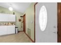 White door with an oval window and adjacent kitchen cabinets at 3007 Fayson Cir, Deltona, FL 32738