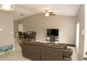 Spacious living room with leather couch and flat-screen TV at 5215 Grandview Dr, Orlando, FL 32808