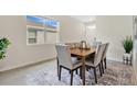 Dining room with a wooden table, six chairs, and an area rug at 7836 June Ln, Wildwood, FL 34785