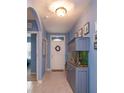 Bright and airy entryway with tile flooring and built-in fish tank at 217 Wood Hollow Rd, Deland, FL 32724