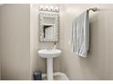 Small powder room with pedestal sink and gray walls at 2469 Seven Oaks Dr, Saint Cloud, FL 34772