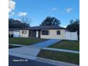 Ranch-style home with a brick facade, white gates, and a grassy front yard at 4523 Ligustrum Way, Orlando, FL 32839