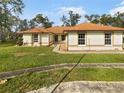 Single story house with a brown roof and a landscaped yard at 5933 Bible Camp Rd, Groveland, FL 34736