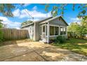 Gray house with a screened porch and a spacious driveway at 628 S Boyd St, Winter Garden, FL 34787