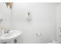 Simple and clean powder room with white sink and toilet at 6824 Perch Hammock Loop, Groveland, FL 34736