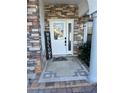 Inviting front entrance with stonework, a decorative doormat and a welcome sign at 761 Americana Ct, Kissimmee, FL 34758