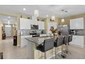 Modern kitchen with granite countertops, stainless steel appliances, and an island at 1189 Cascade Dr, Davenport, FL 33837