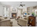 Bright living room with fireplace, built-in shelving, and ample natural light at 1556 Auburn Oaks Ct, Auburndale, FL 33823