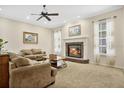 Spacious living room featuring a fireplace, comfortable seating, and large windows at 1556 Auburn Oaks Ct, Auburndale, FL 33823