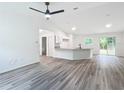 Open concept kitchen with granite countertops, white cabinets, and LVP flooring at 22474 Sw Rainbow Lakes Blvd, Dunnellon, FL 34431