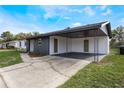 Covered carport with concrete flooring and two access doors at 4856 Victory Dr, Orlando, FL 32808