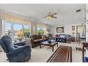 Bright living room with large windows, comfy seating, and a coffee table at 6399 Lolly Bay Ne Loop, Winter Haven, FL 33881