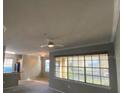 Bright living room with large windows and ceiling fan at 2598 Robert Trent Jones Dr # 1010, Orlando, FL 32835