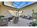 Relaxing covered patio with seating area and fire pit at 3875 Grassland Loop, Lake Mary, FL 32746
