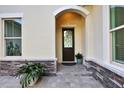 Elegant front entry with arched entryway and decorative door at 3875 Grassland Loop, Lake Mary, FL 32746