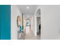 Bright and spacious entryway with glass-top table and mirror at 4133 Giorgio Dr, Winter Haven, FL 33884