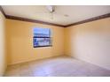 Simple bedroom with tile floors and a window at 79 Lake Villa Way, Kissimmee, FL 34743