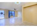 Open living room with tile floors and access to the kitchen at 79 Lake Villa Way, Kissimmee, FL 34743