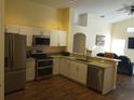 Modern kitchen with stainless steel appliances and granite countertops at 7947 Golden Pond Cir, Kissimmee, FL 34747