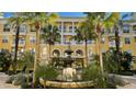 Condo building with fountain and tropical landscaping at 860 N Orange Ave # 118, Orlando, FL 32801