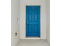 Eye-catching teal front door with a six-panel design at 1731 Durden Dr, Winter Haven, FL 33880