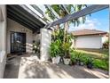 Covered entryway with black door and potted plants at 2216 Greenview Cir, Orlando, FL 32808