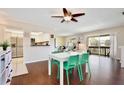 Open concept dining area with kitchen view and hardwood floors at 600 Northern Way # 1608, Winter Springs, FL 32708