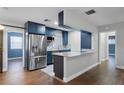 Modern kitchen featuring stainless steel appliances and blue cabinetry at 36 Marigold Ln, Debary, FL 32713
