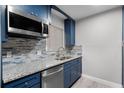 Renovated kitchen with granite countertops and stylish blue cabinets at 36 Marigold Ln, Debary, FL 32713