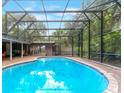 Inviting kidney shaped pool with a screened enclosure in the backyard at 402 Satsuma Dr, Sanford, FL 32771
