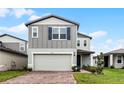 Two-story house with gray siding, brick driveway and landscaping at 4932 Mainsail St, Haines City, FL 33844