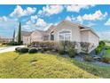 Well-maintained home with lush landscaping and a two-car garage at 5810 Penney Ln, The Villages, FL 32163