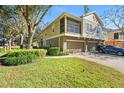 Townhouse exterior showcasing a two-car garage and landscaped yard at 973 Ashworth Overlook Dr # A, Apopka, FL 32712