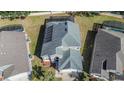 House with solar panels, pool, and surrounding homes visible from above at 8048 King Palm Cir, Kissimmee, FL 34747