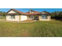 House exterior features a brown roof, light-colored siding, and a front porch at 10181 Sw 46 Ct, Ocala, FL 34476