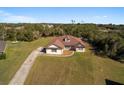 Property showcasing a house with a spacious backyard and a long driveway at 10181 Sw 46 Ct, Ocala, FL 34476