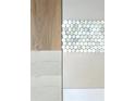Close-up of bathroom tile samples, showcasing various textures and colors at 415 Se 1St Ave # 101-A, Ocala, FL 34471