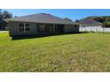 Gray house exterior with large backyard and patio at 7830 Sw 103Rd Loop, Ocala, FL 34476