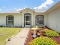 House exterior with landscaped walkway and bird bath at 16290 Sw 17Th Ave, Ocala, FL 34473