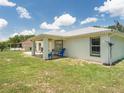House exterior showcasing a backyard patio and grassy lawn at 16290 Sw 17Th Ave, Ocala, FL 34473