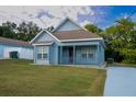 Light blue house with front porch and yard at 535 W Silver Springs Pl, Ocala, FL 34475
