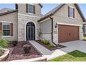 Two-story house with stone accents, brown garage door, and landscaping at 6701 Sw 94Th Cir, Ocala, FL 34481