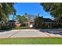 Brick home with a large driveway and mature trees at 1321 Sw 42Nd St, Ocala, FL 34471